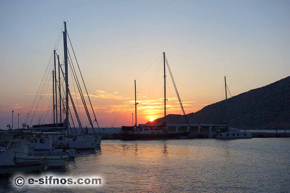 Sailing boats at the port of Sifnos, at the sunset