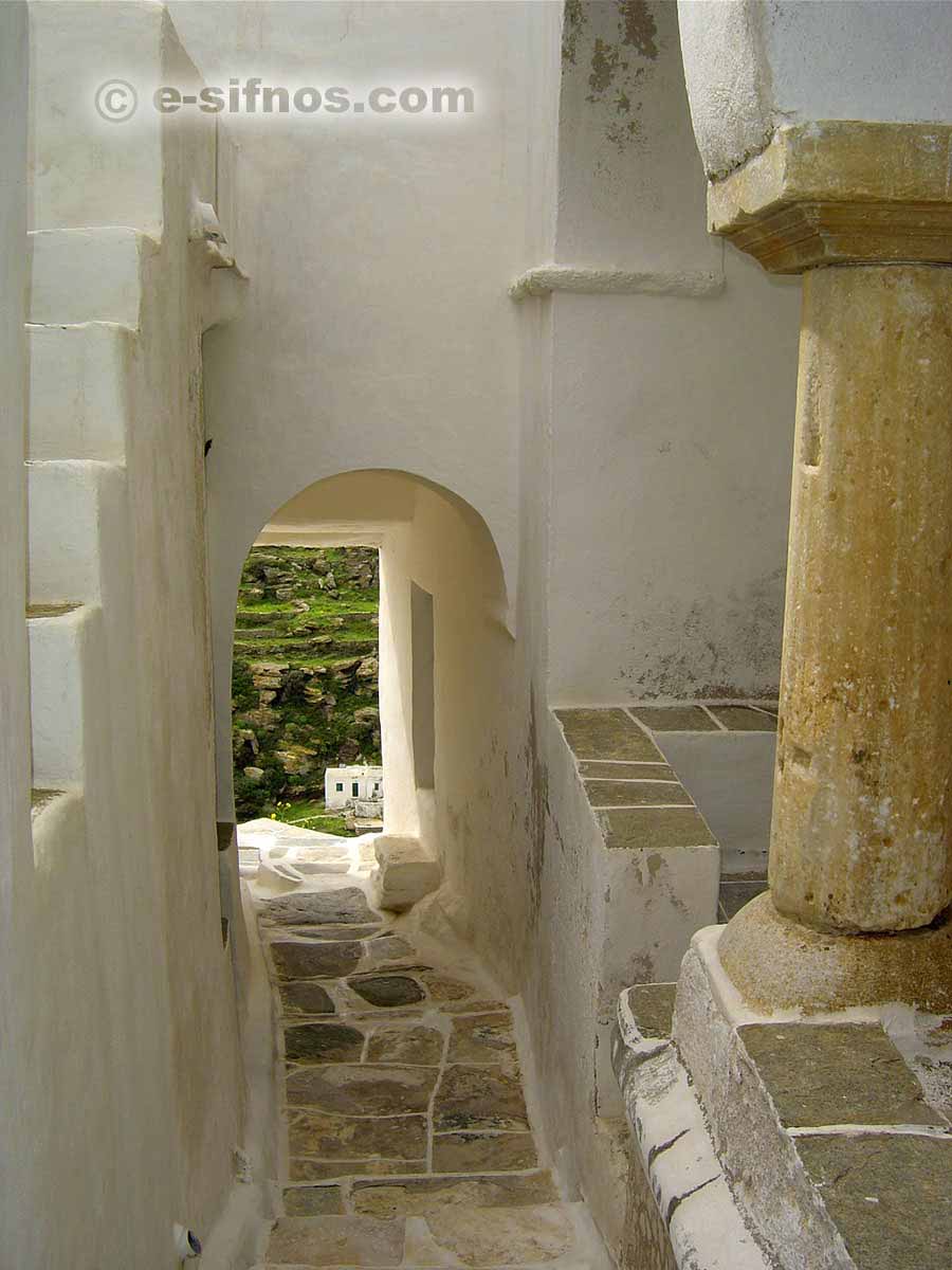 Alley at Kastro village with an ancient column