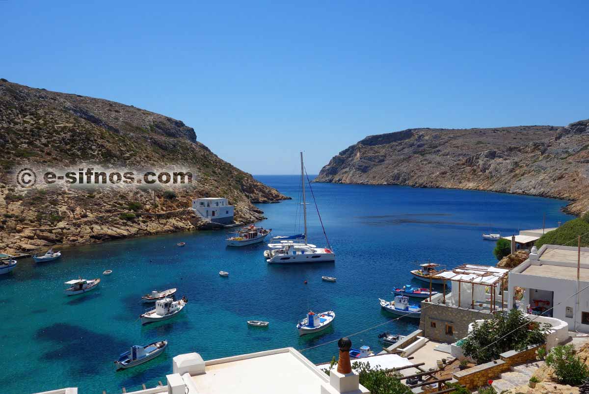 Traditional fishing boats and a sailing boat in Cheronissos